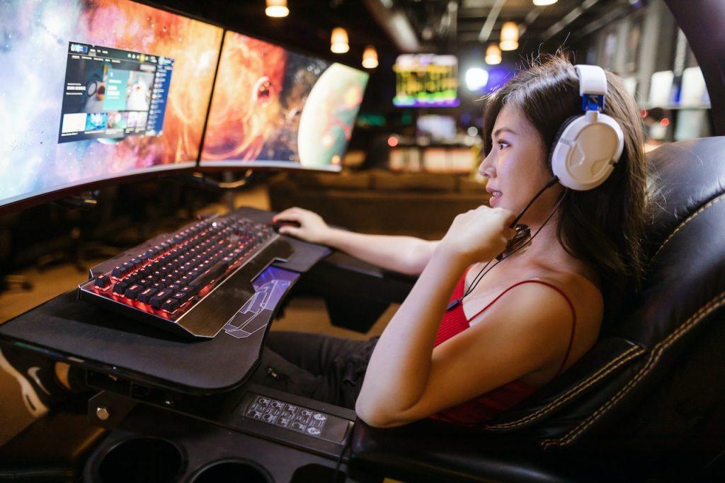 Best Survival Games A Comprehensive Guide to the Top Ones, a woman playing video games on a wide screen